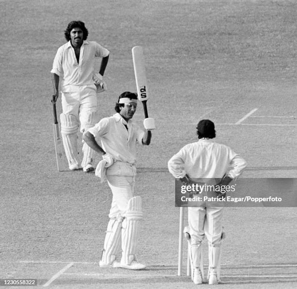 Pakistan batsman Zaheer Abbas raises his bat on reaching his century during his innings of 235 in the 2nd Test match between Pakistan and India at...