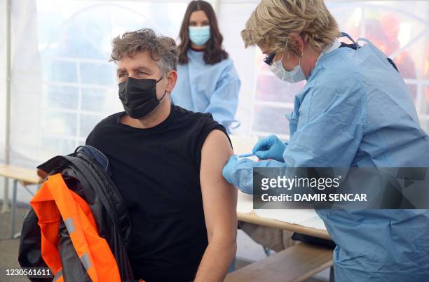 Man gets the Moderna Covid-19 vaccine, in a Red Cros medical tent in Petrinja, some 50 kilometres from Zagreb, on January 13 after a powerful...