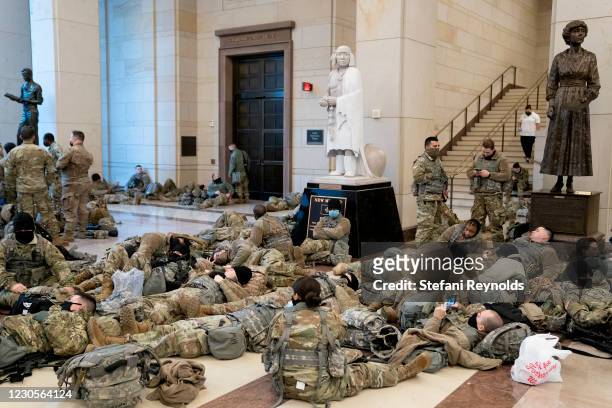 Members of the National Guard rest in the Visitor Center of the U.S. Capitol on January 13, 2021 in Washington, DC. Security has been increased...