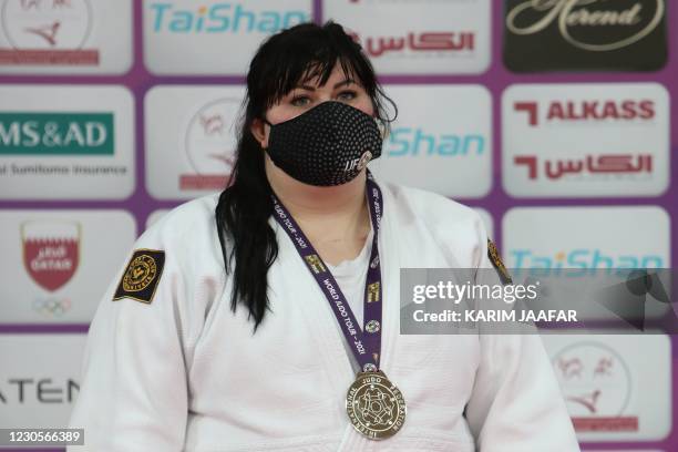 Azerbaijan's Iryna Kindzerska poses on podium with her medal during the World Judo Masters in the Qatari capital Doha, on January 13, 2021.