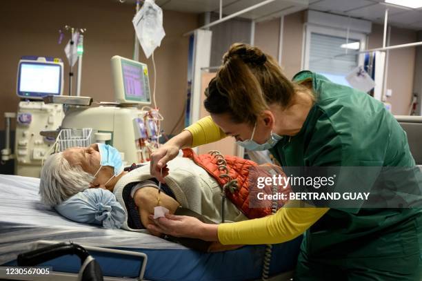 Dialysis patient receives the Pfizer-BioNTech Covid-19 vaccine in a private clinic in Aulnay-sous-Bois, on January 13, 2021.