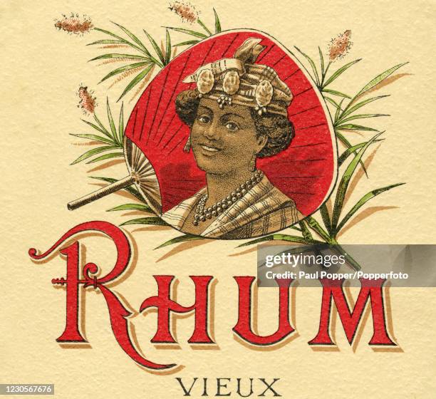 Vintage illustration advertising Old Rum from Jamaica and featuring a young woman in traditional dress superimposed on a fan surrounded with...