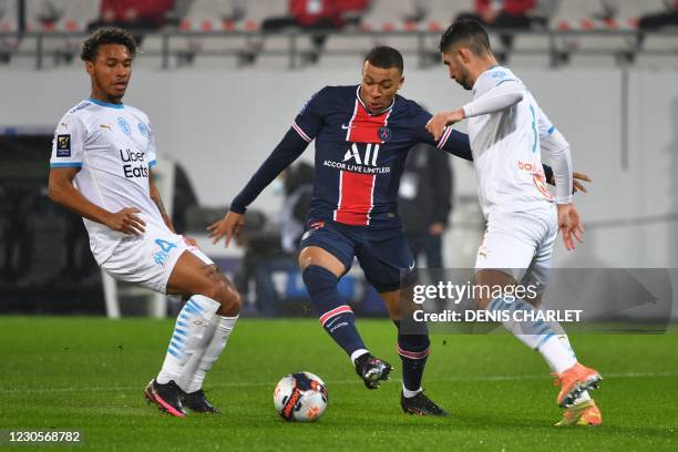 Paris Saint-Germain's French forward Kylian Mbappe vies for the ball with Marseille's Spanish defender Alvaro Gonzalez and Marseille's French...