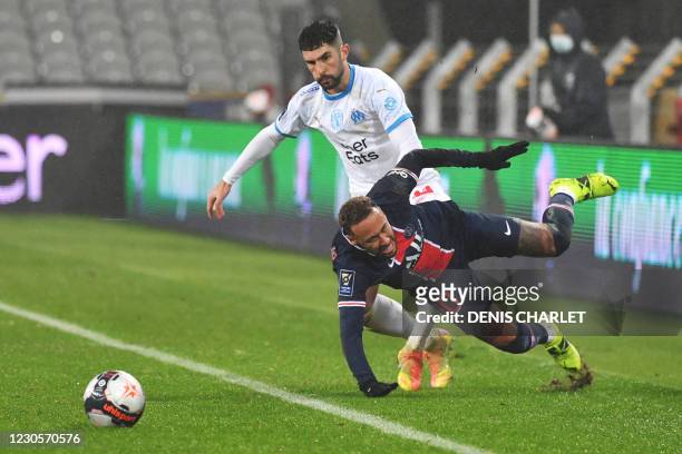 Paris Saint-Germain's Brazilian forward Neymar falls as he vies for the ball with Marseille's Spanish defender Alvaro Gonzalez during the French...