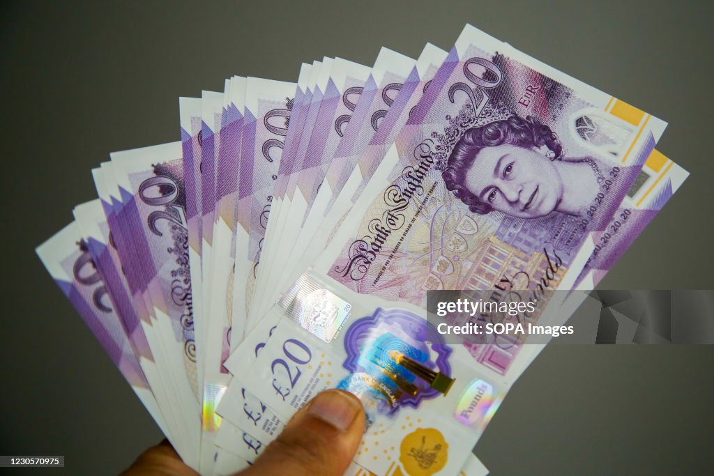 In this photo illustration, a person holding British twenty...