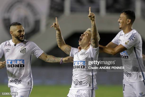Brazil's Santos Venezuelan Yeferson Soteldo celebrates with teammates Para and Diego Pituca after scoring against Argentina's Boca Juniors during...