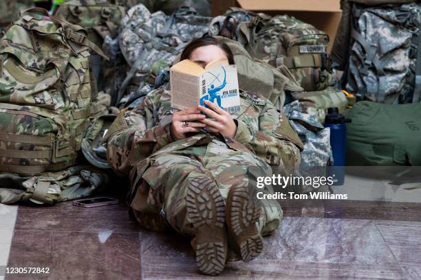 Member of the National Guard reads Atlas Shrugged in the Capitol Visitor Center as the House debates an article of impeachment against President...