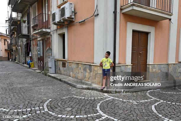 Child stands on a street of the old center in the town of Cinquefrondi in Calabria region in south Italy, on July 6, 2020. - Italian juvenile judge...
