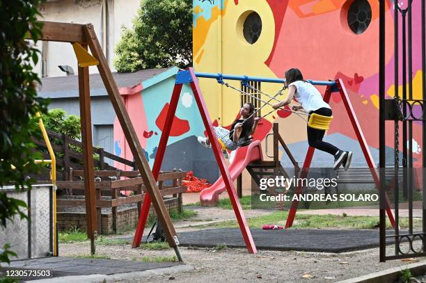 Girls swing at a children's playground at the Villa Comunale in the town of Cinquefrondi in Calabria region in Southern Italy, on July 6, 2020. -...