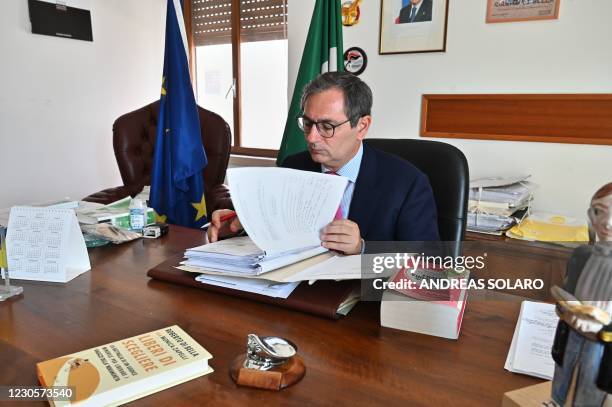 Italian judge Roberto Di Bella looks at documents during an interview at his office in the Juvenile Court in Reggio Calabria, Calabria, southern...