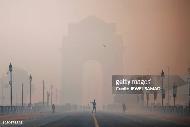 Soldier walks along a street near India Gate amid smoggy conditions in New Delhi on January 14, 2021.