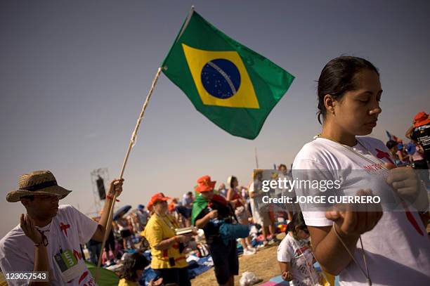 Brazilian pilgrims attend a mass celebrated by Pope Pope Benedict XVI at the base of Cuatro Vientos, eight kilometres southwest of Madrid on August...