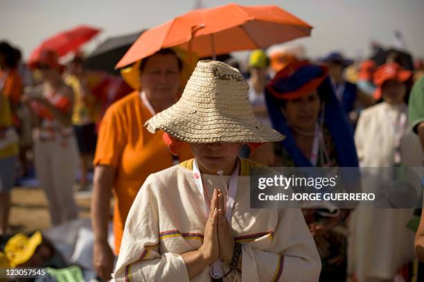 Pilgrim prays during a mass celebrated by Pope Pope Benedict XVI at the base of Cuatro Vientos, eight kilometres southwest of Madrid on August 21,...