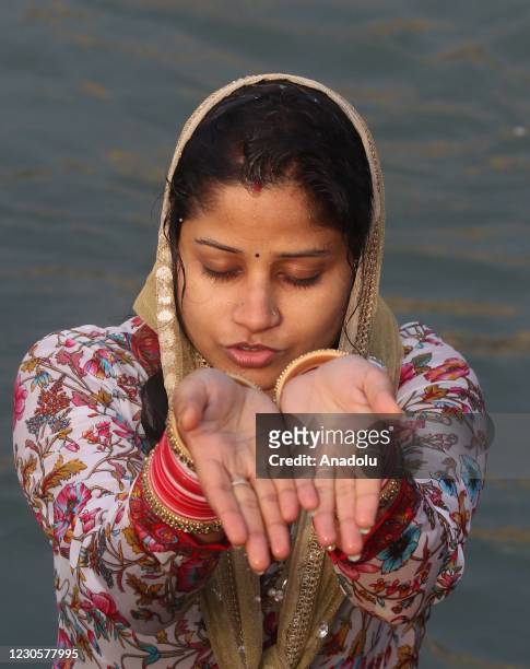 Indian Hindu devotee takes a holy dip in the waters of river Ganges during Makar Sankranti, a day considered to be great religious significance in...