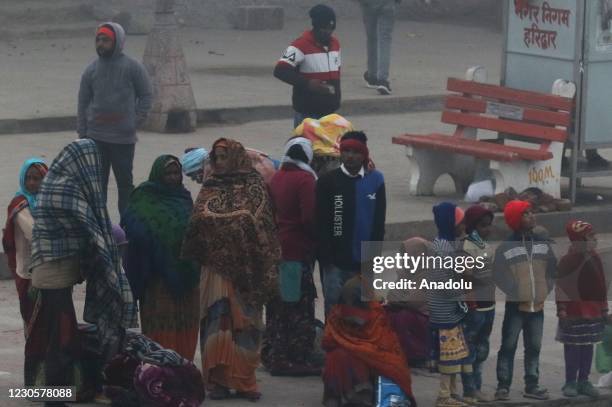 Indian Hindu devotees arrive to take a holy dip in the waters of river Ganges during Makar Sankranti, a day considered to be great religious...