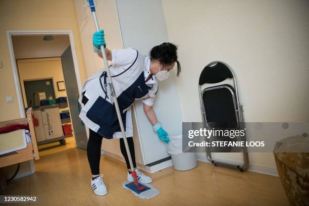 Cleaning woman Izabela Pacyniak wears a face mask as she works in a nursing home, on January 14, 2021 in Berlin amid the novel coronavirus COVID-19...