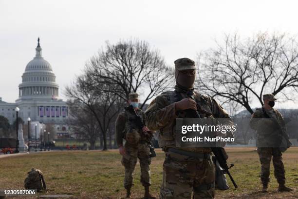 Members of the National Guard gather at the US Capitol a day after The House of Representatives impeached President Trump for inciting an...