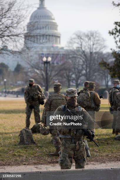 Members of the National Guard gather at the US Capitol a day after The House of Representatives impeached President Trump for inciting an...