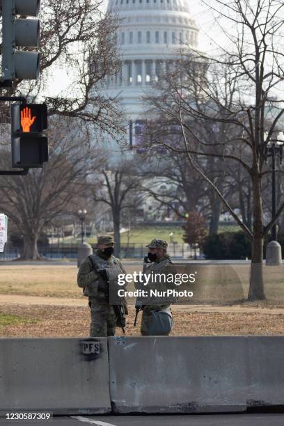 Members of the National Guard gather at the US Capitol a day after The House of Representatives impeached President Trump for inciting an...