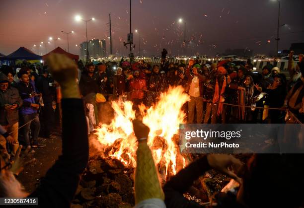 Farmers shout slogan against Indian prime minister Narendra Modi as they celebrate the Lohri festival, at the site of farmers protest against the new...