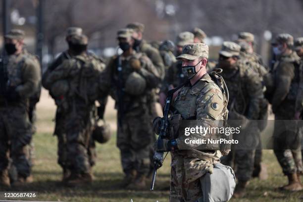 Members of the National Guard gather at the US Capitol a day after The House of Representatives impeached President Trump for inciting an...