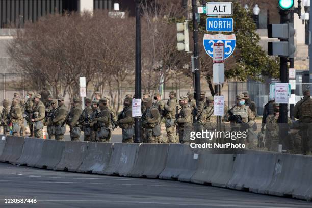 Members of the National Guard gather at the US Capitol a day after The House of Representatives impeached President Trump for inciting an...