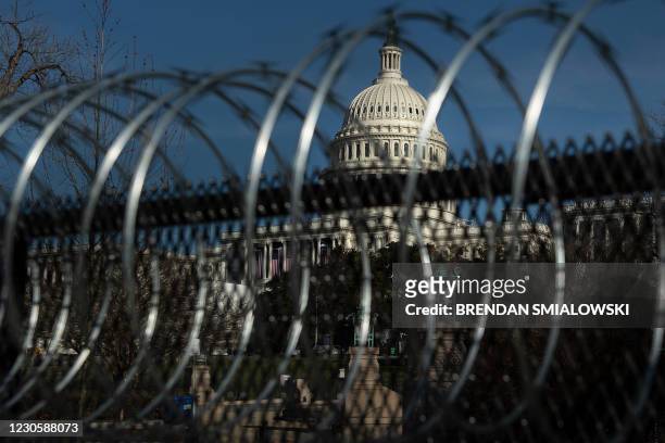Razor wire is seen topping security fence, after a pro-Trump mob broke into and took over the Capitol, in preparation for next week's Presidential...