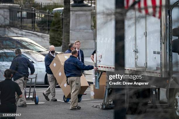 Workers move boxes onto a truck on West Executive Avenue between the West Wing of the White House and the Eisenhower Executive Office Building at the...