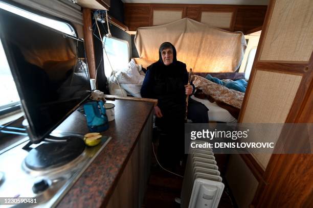 Bara Vrbanac from the village of Sibic, in central Croatia, sits in a snow-covered camper van where she is living after her house was badly damaged...