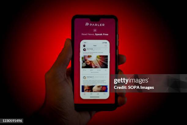 In this photo illustration the Parler smartphone App is seen displayed on a smartphone. The 'free speech' social media platform, Parler, a hit with...