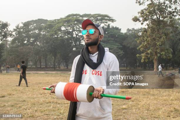 Boy prepares to fly a kite on the occasion of Shakrain festival. Shakrain Festival also known as Kite festival is an annual celebration of winter in...