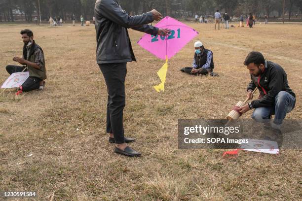 Group of boys boy prepares to fly a kite on the occasion of Shakrain festival. Shakrain Festival also known as Kite festival is an annual celebration...