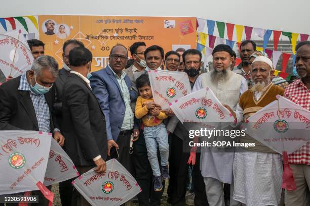 Group of people pose with kites for a photo during the Shakrain festival. Shakrain Festival also known as Kite festival is an annual celebration of...