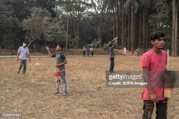 Group of boys prepares to fly a kite on the occasion of Shakrain Festival. Shakrain Festival also known as Kite festival is an annual celebration of...