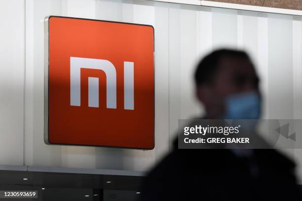 Man walks past a Xiaomi store in Beijing on January 15 as shares in the company collapsed on January 15 after the United States blacklisted the...