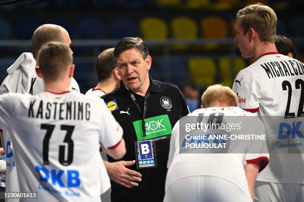 Germany's coach Alfred Gislason gives instructions to his players during the 2021 World Men's Handball Championship between Group A teams Germany and...