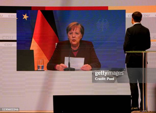 Paul Ziemiak, secretary general of the Christian Democratic Union listens to the speech of German Chancellor Angela Merkel during the CDU party...