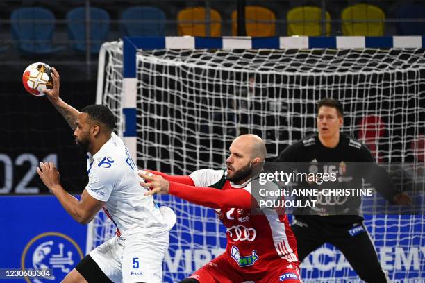 Cape Verde's left back Edmilson Araujo is challenged by Hungary's pivot Adrian Sipos during the 2021 World Men's Handball Championship between Group...