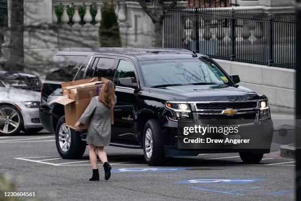 Woman carries boxes out of the West Wing of the White House on January 15, 2021 in Washington, DC. According to recent news reports, President Donald...