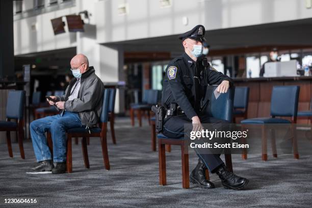 People wait for 15 minutes after receiving their COVID-19 vaccine at Gillette Stadium on January 15, 2021 in Foxborough, Massachusetts. First...