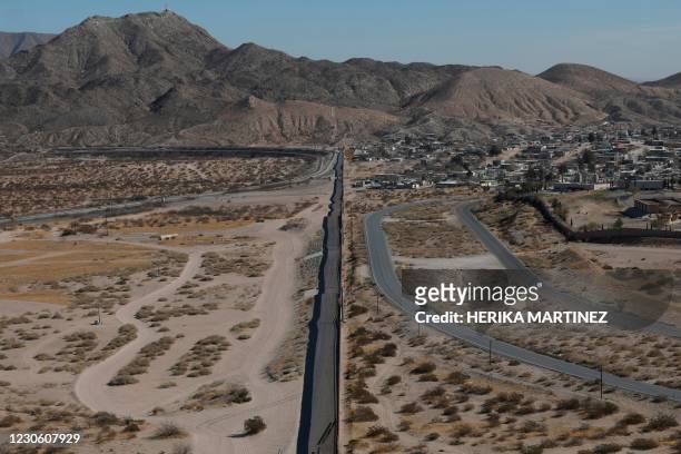 Aerial view of US workers building the new 13-mile border wall construction project at the desert between Sunlad Park, New Mexico, US and Ciudad...