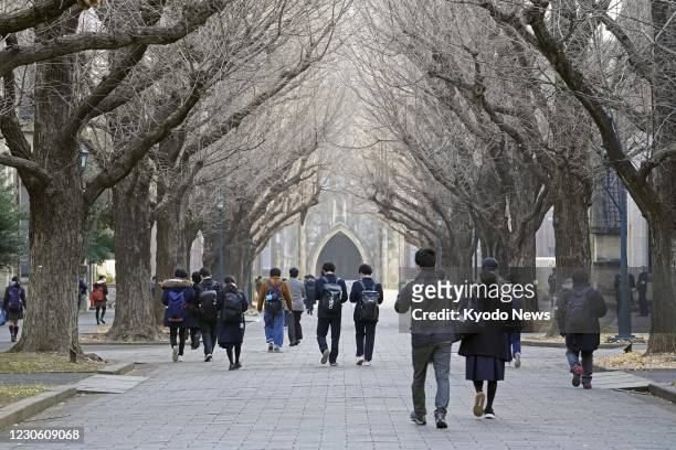 Students walk to the venue of their entrance exams at the University of Tokyo on Jan. 16, 2021. Japan's new unified university entrance exams started...