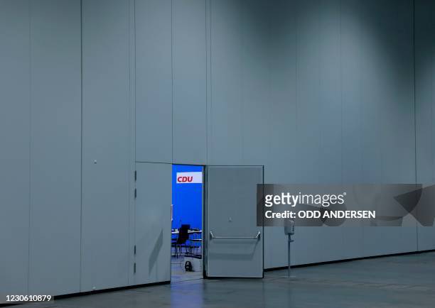 The CDU logo is seen behind an open door on the second day of the Christian Democratic Union party's 33rd congress held online because of the...