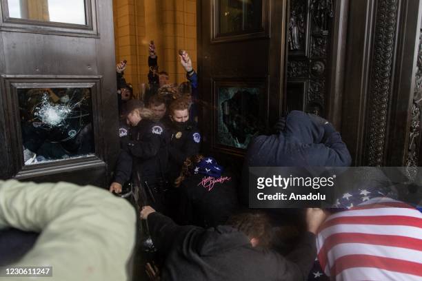Police intervenes in US President Donald Trumps supporters who breached security and entered the Capitol building in Washington D.C., United States...