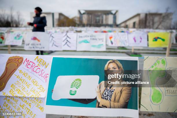 January 2021, Berlin: A photo of Julia Klöckner , Federal Minister of Food and Agriculture, with a green footprint hangs in the "Aktion Fußabdruck"...