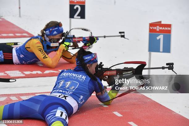 Belarus' Elena Kruchinkina and Germany's Franziska Preuss shoot during the women's 4x6km relay event of the IBU Biathlon World Cup in Oberhof,...