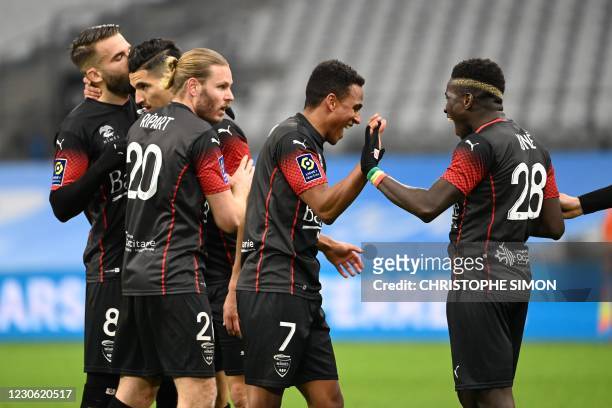 Nimes' Swedish midfielder Niclas Eliasson celebrates his second goal with teammates during the French L1 football match between Olympique de...