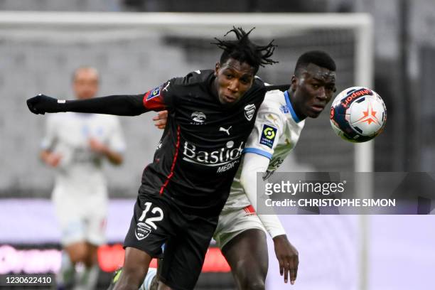 Marseille's French midfielder Pape Gueye vies with Nimes' French midfielder Lamine Fomba during the French L1 football match between Olympique de...