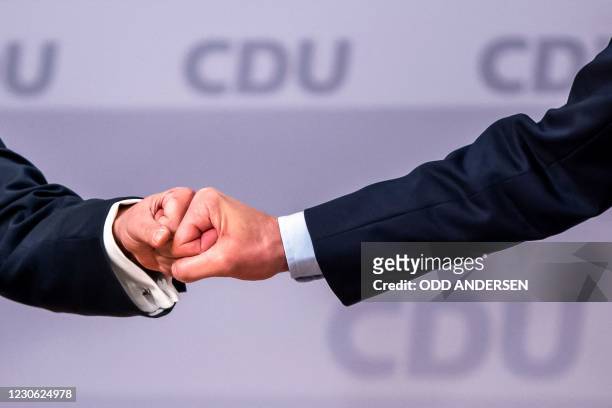North Rhine-Westphalia's State Premier and new leader of the Christian Democratic Union Armin Laschet does a fist bump with candidate as leader of...