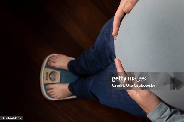 Bonn, Germany In this photo illustration a woman controls her weight on January 14, 2021 in Bonn, Germany.